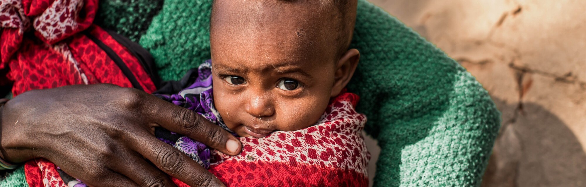 Tume, 37, holds her baby son Nyare in her arms  