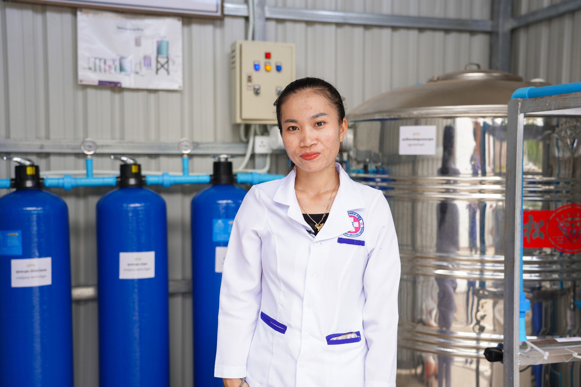 Chou KimCheng with the new water filtration system  